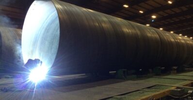 welder working on industrial piping