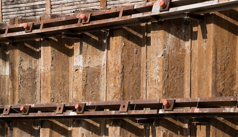 Sheet piling pile wall with soldier pile wall